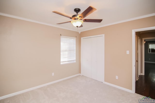 unfurnished bedroom with baseboards, carpet, and ornamental molding