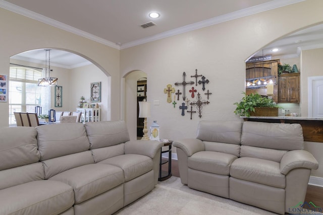 living room featuring light hardwood / wood-style flooring and crown molding