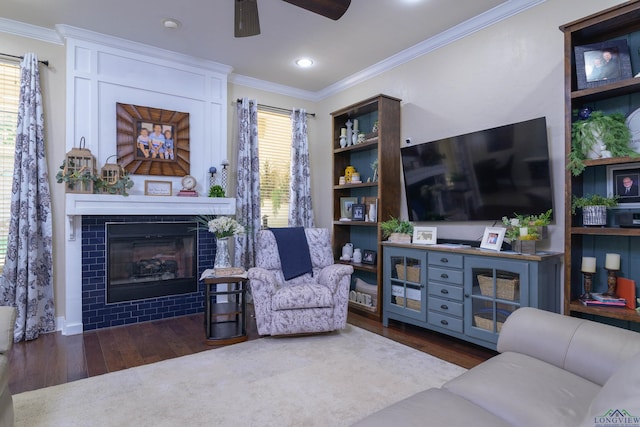 living room with dark hardwood / wood-style flooring, ceiling fan, and ornamental molding