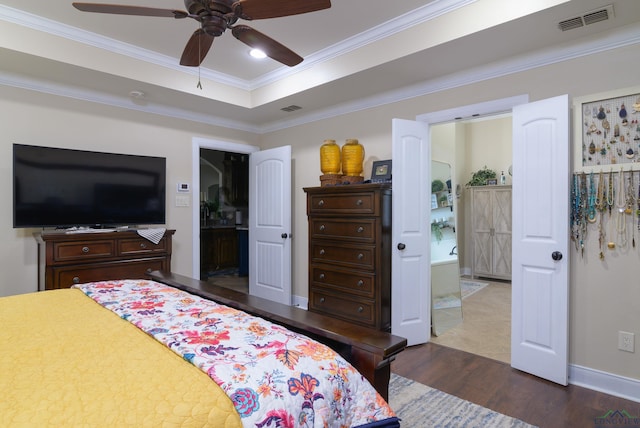 bedroom featuring connected bathroom, ceiling fan, dark wood-type flooring, and ornamental molding