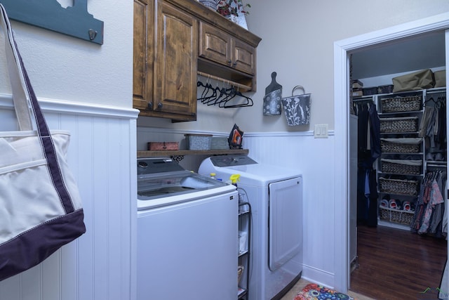 clothes washing area with cabinets, washer and dryer, and dark hardwood / wood-style floors