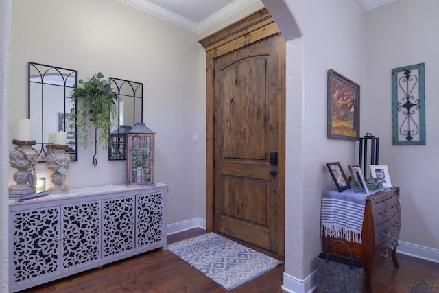 entrance foyer with dark hardwood / wood-style floors and ornamental molding