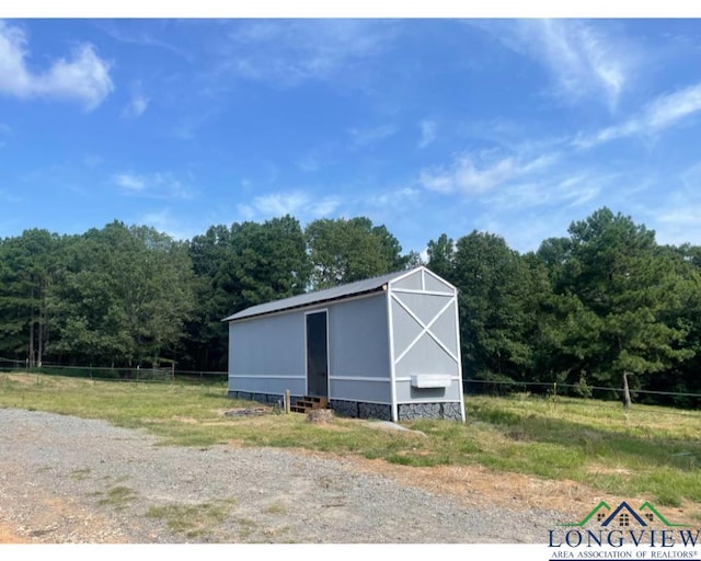 view of outdoor structure with a rural view