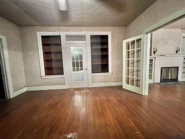 interior space featuring a fireplace and dark hardwood / wood-style floors