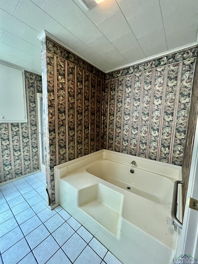 bathroom with a bath and tile patterned floors