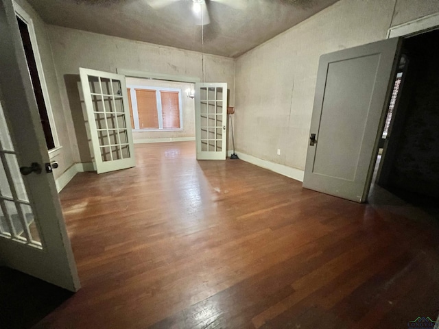 unfurnished room featuring french doors and dark wood-type flooring