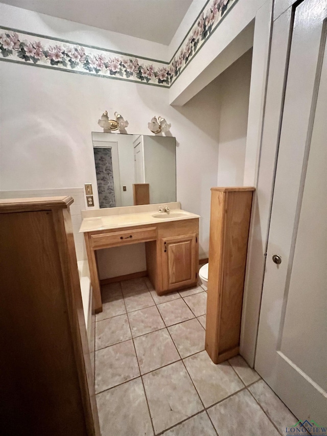 bathroom featuring toilet, vanity, and tile patterned floors