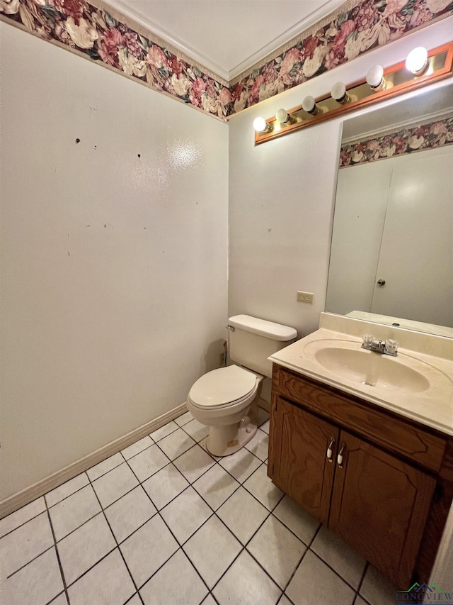 bathroom featuring tile patterned flooring, vanity, toilet, and crown molding