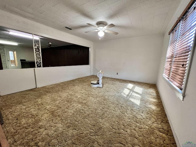 spare room with carpet flooring and ceiling fan