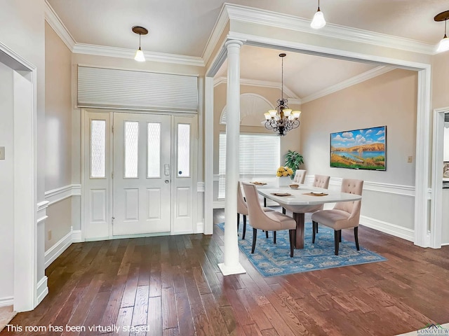 foyer with crown molding, dark wood-style flooring, baseboards, ornate columns, and a chandelier
