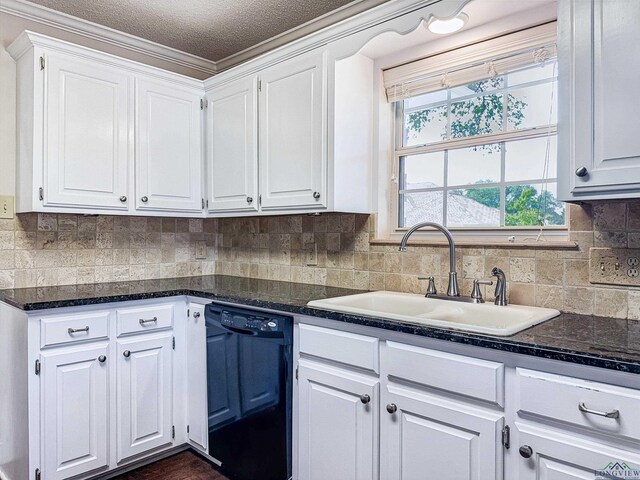 kitchen featuring decorative backsplash, dishwasher, a sink, dark stone counters, and white cabinetry