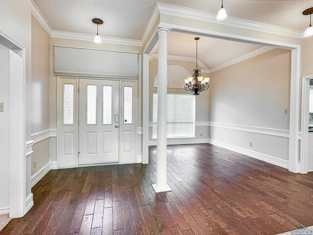 foyer entrance with plenty of natural light, decorative columns, and dark wood-style floors