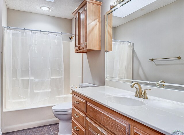 bathroom with vanity, toilet, tile patterned floors, a textured ceiling, and shower / tub combo