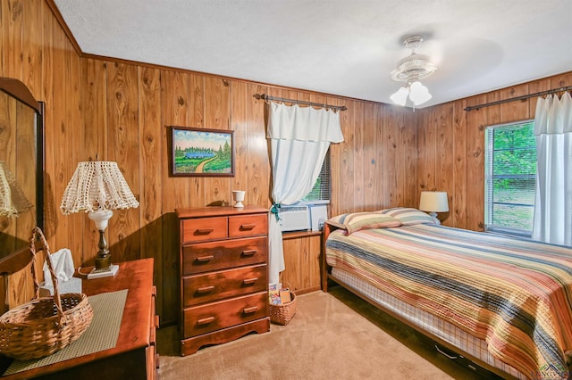 350 Capri St, Ore City, TX 75683 - bedroom with wooden walls, carpet floors, cooling unit, and a textured ceiling
