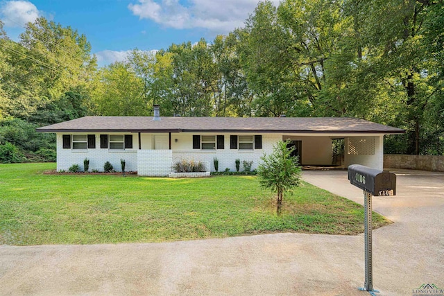 ranch-style home with a front yard and a carport