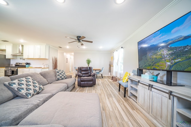 living room featuring light hardwood / wood-style floors, ceiling fan, and crown molding