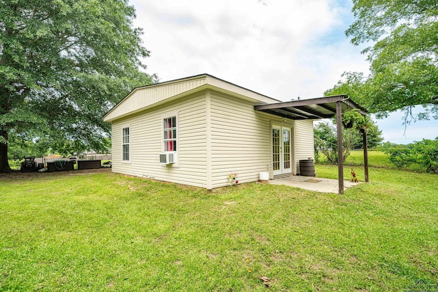 view of side of home featuring a yard, a patio area, french doors, and cooling unit