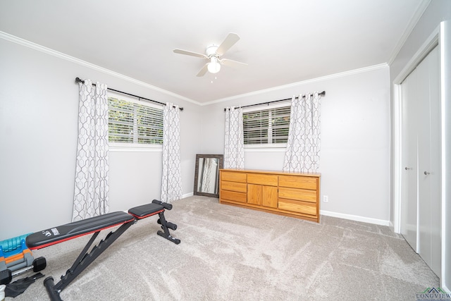 workout room with ceiling fan, light colored carpet, and ornamental molding