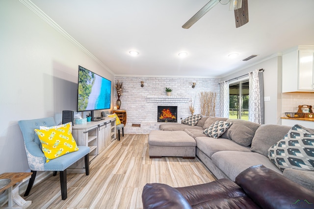 living room with a fireplace, ceiling fan, ornamental molding, and brick wall