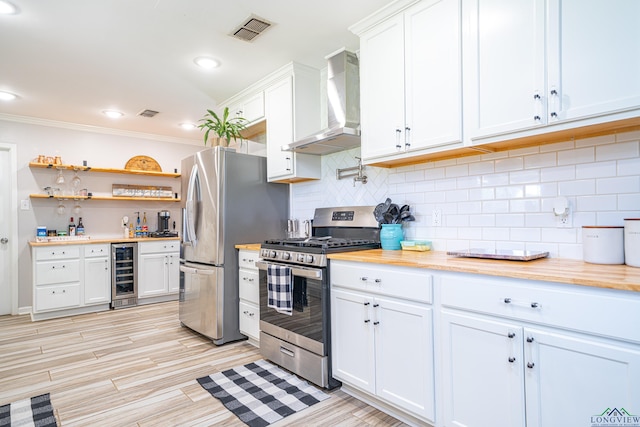 kitchen with white cabinetry, wall chimney exhaust hood, stainless steel appliances, beverage cooler, and backsplash