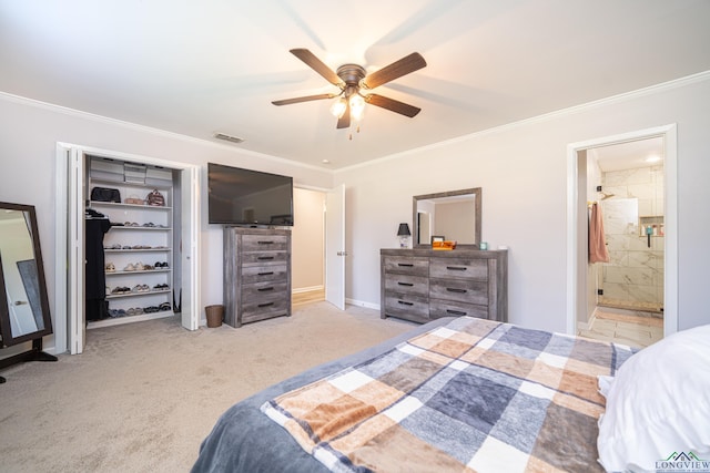 carpeted bedroom with ceiling fan, a closet, crown molding, and ensuite bath