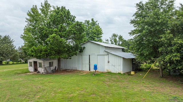 view of outbuilding featuring a yard