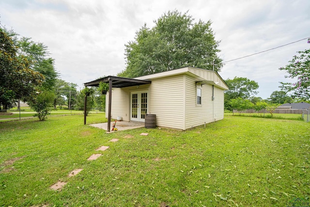 view of property exterior featuring a yard and french doors