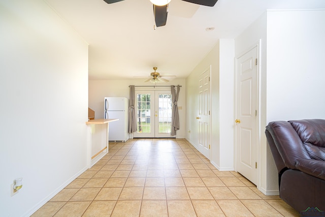 tiled foyer with ceiling fan and french doors