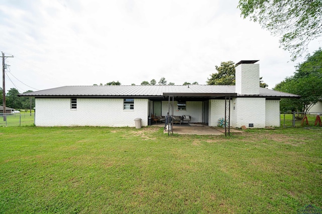 back of property featuring a lawn and a patio area