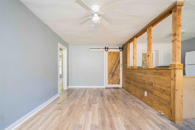 115 Yates St, Mount Vernon, TX 75457 - spare room with wood finished floors, a ceiling fan, baseboards, and wooden walls