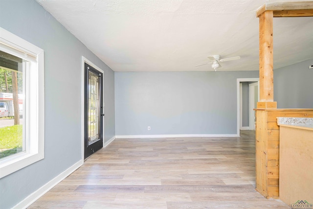 115 Yates St, Mount Vernon, TX 75457 - unfurnished living room with light wood-style flooring, ceiling fan, and baseboards