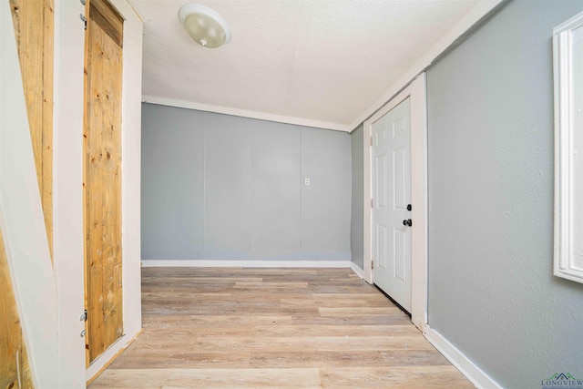 115 Yates St, Mount Vernon, TX 75457 - entrance foyer featuring wood finished floors, baseboards, and a textured ceiling