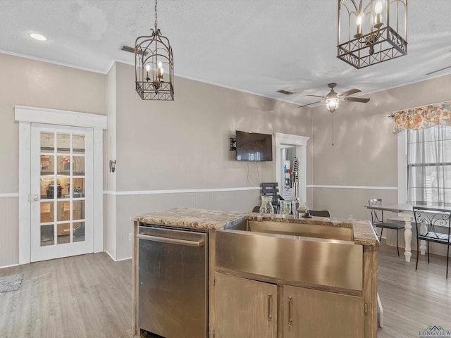 kitchen featuring a sink, dishwasher, decorative light fixtures, ceiling fan with notable chandelier, and light wood-type flooring