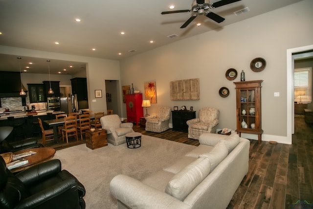 living room with ceiling fan and dark wood-type flooring