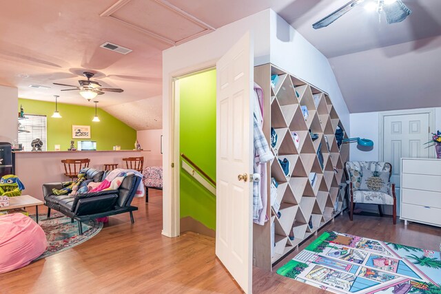 interior space with hardwood / wood-style flooring, ceiling fan, and lofted ceiling