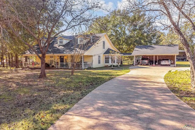 cape cod-style house featuring a porch and a carport