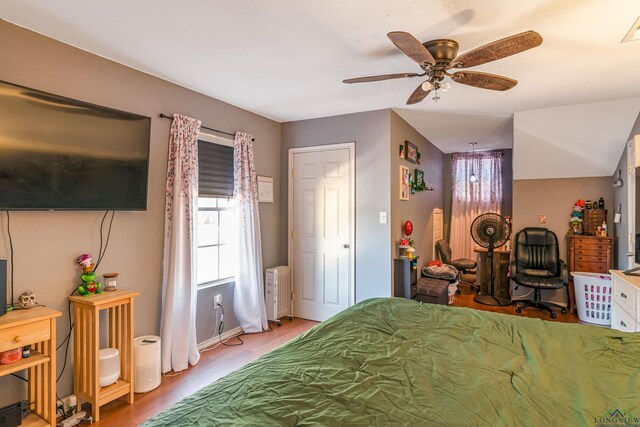 bedroom featuring radiator, ceiling fan, and light hardwood / wood-style floors