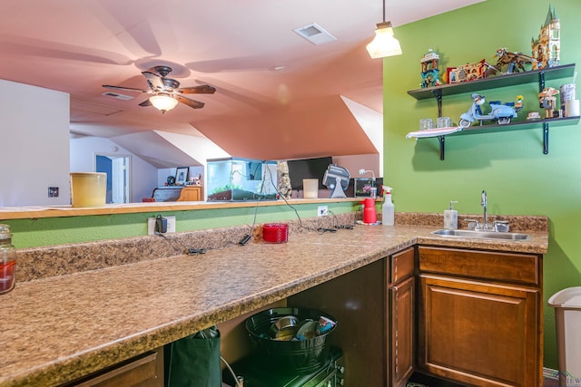 kitchen with decorative light fixtures, ceiling fan, lofted ceiling, and sink