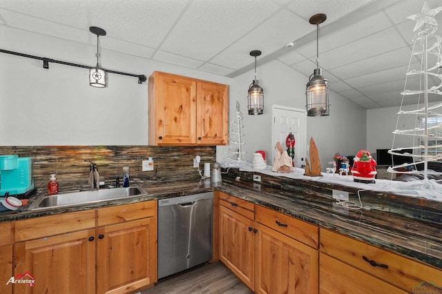 kitchen with dishwasher, sink, pendant lighting, a paneled ceiling, and decorative backsplash