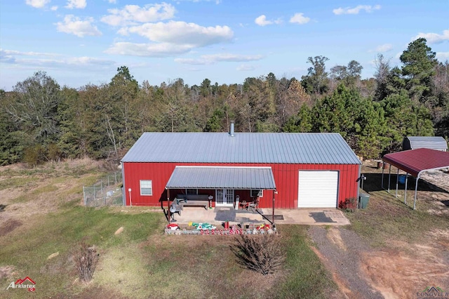 view of outdoor structure with a garage and a carport