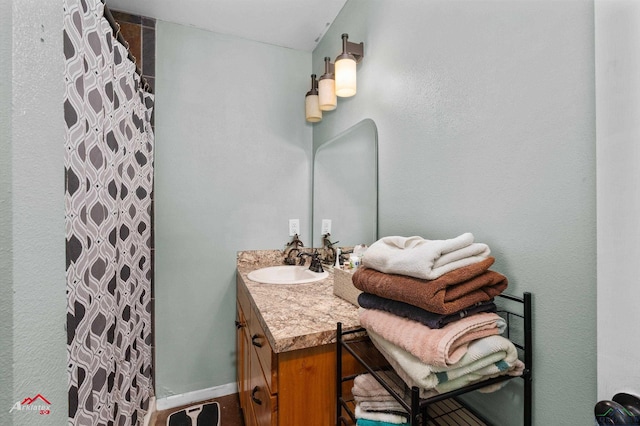 bathroom featuring vanity and a shower with shower curtain