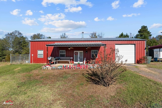 view of front of house with ceiling fan, french doors, and a front lawn