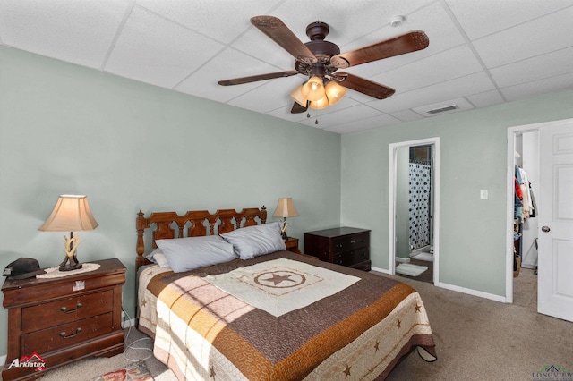 bedroom with carpet, ceiling fan, and a drop ceiling