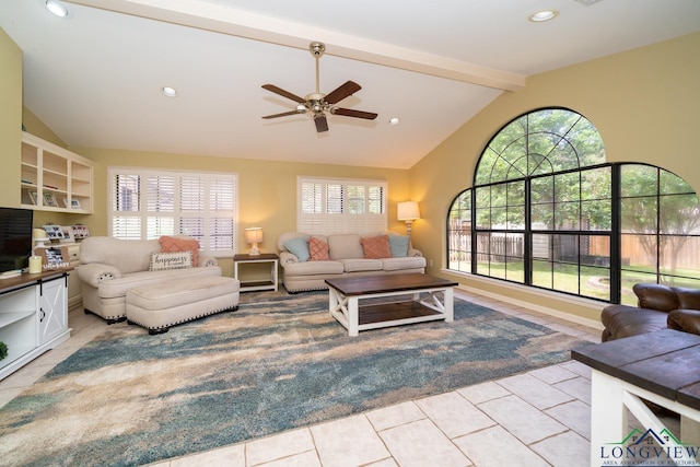 1002 Ruby St, Gilmer, TX 75644 - living area featuring lofted ceiling with beams, light tile patterned floors, ceiling fan, and a healthy amount of sunlight