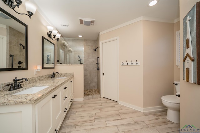 1002 Ruby St, Gilmer, TX 75644 - full bathroom featuring toilet, a sink, visible vents, and tiled shower