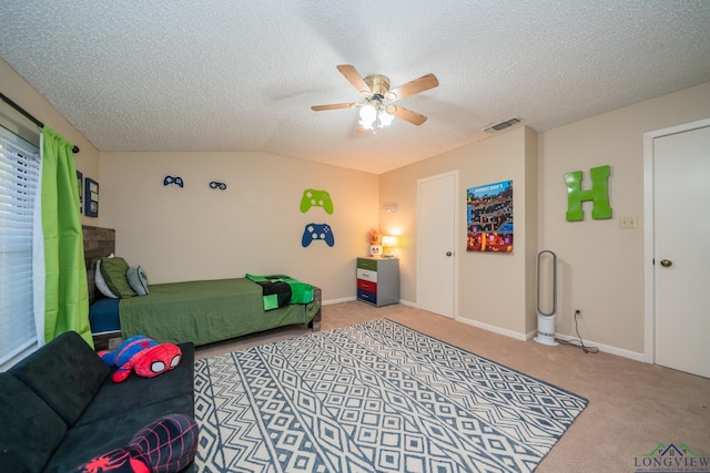 1002 Ruby St, Gilmer, TX 75644 - carpeted bedroom with ceiling fan, vaulted ceiling, a textured ceiling, and baseboards