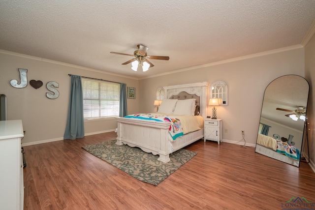 1002 Ruby St, Gilmer, TX 75644 - bedroom with ornamental molding, wood finished floors, and a textured ceiling
