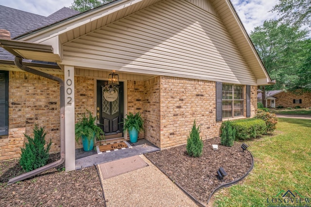 1002 Ruby St, Gilmer, TX 75644 - property entrance with brick siding and a yard