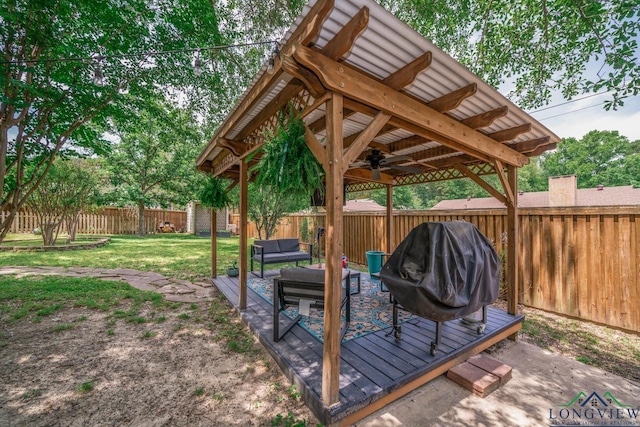 1002 Ruby St, Gilmer, TX 75644 - deck with a fenced backyard, a gazebo, outdoor lounge area, ceiling fan, and a yard