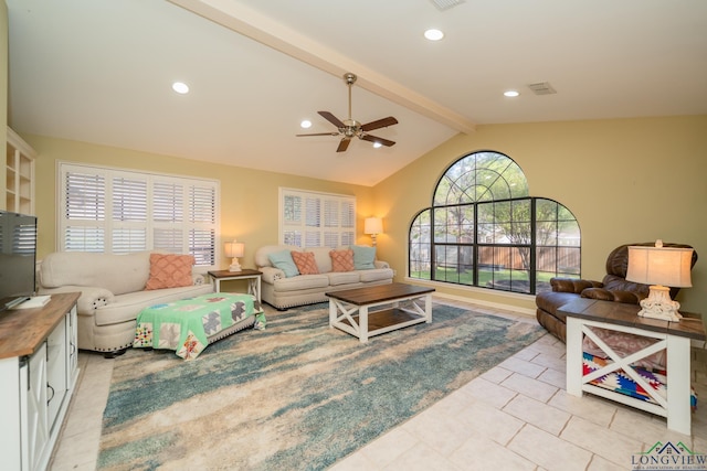 1002 Ruby St, Gilmer, TX 75644 - living area featuring lofted ceiling with beams, a ceiling fan, visible vents, and plenty of natural light